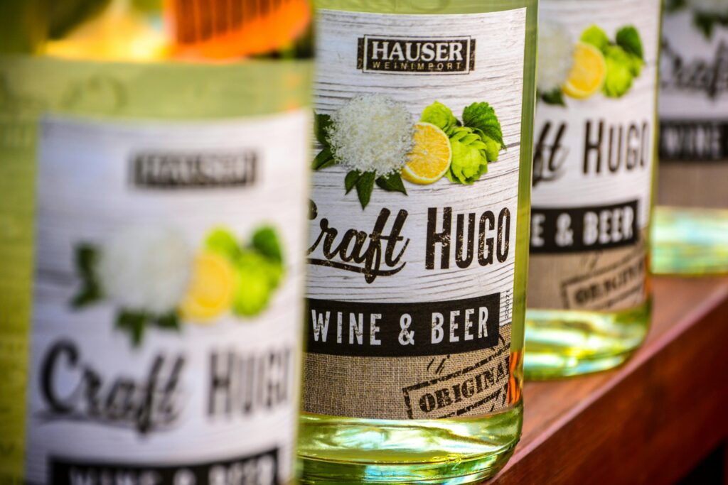 Detailed view of Craft Hugo wine and beer bottles highlighting branding and labels.